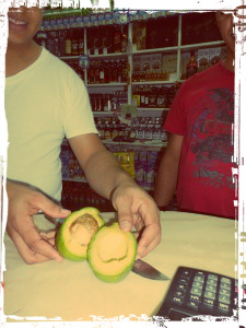 Cutting open the avocado in a colmado