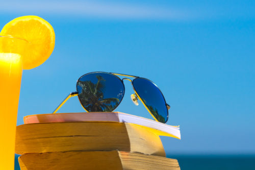 Books and sunglasses on a beach